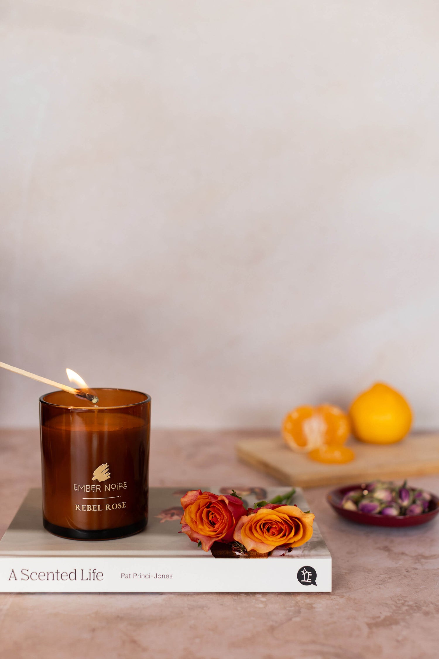 Rebel Rose scented Candle – pink-toned styled image with amber jar and dried florals – floral aromatherapy soy candle