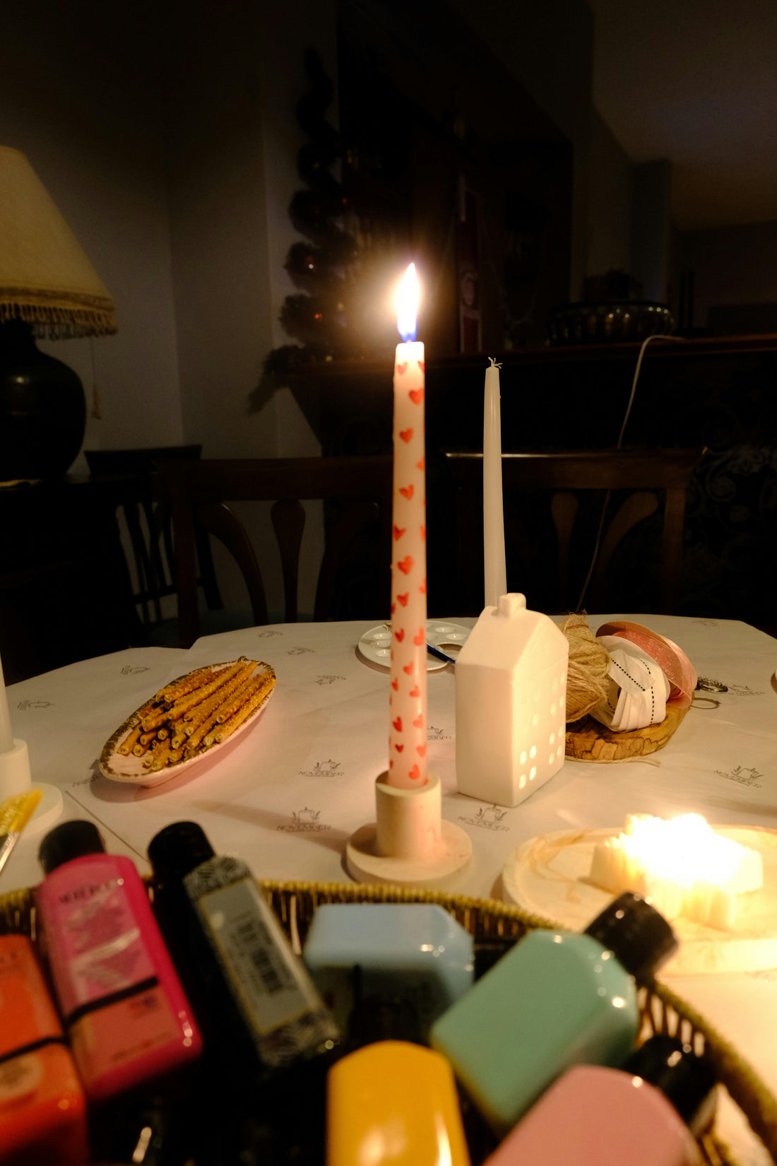 Cozy candlelit scene showing a natural soy wax candle burning in a warm interior