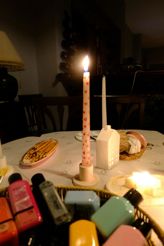 Cozy candlelit scene showing a natural soy wax candle burning in a warm interior