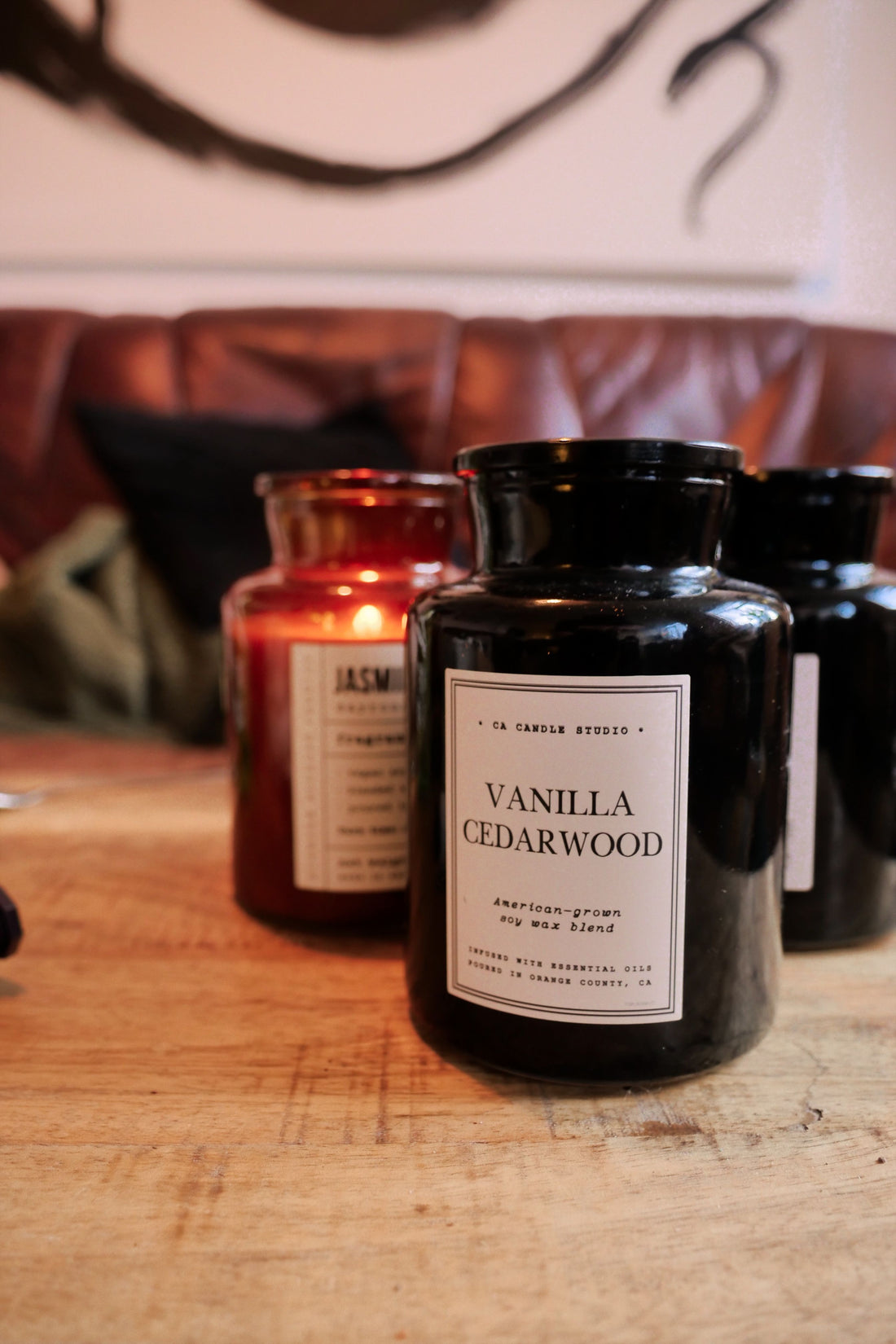 Warm candlelit setting featuring a Vanilla Cedarwood candle on a wooden table