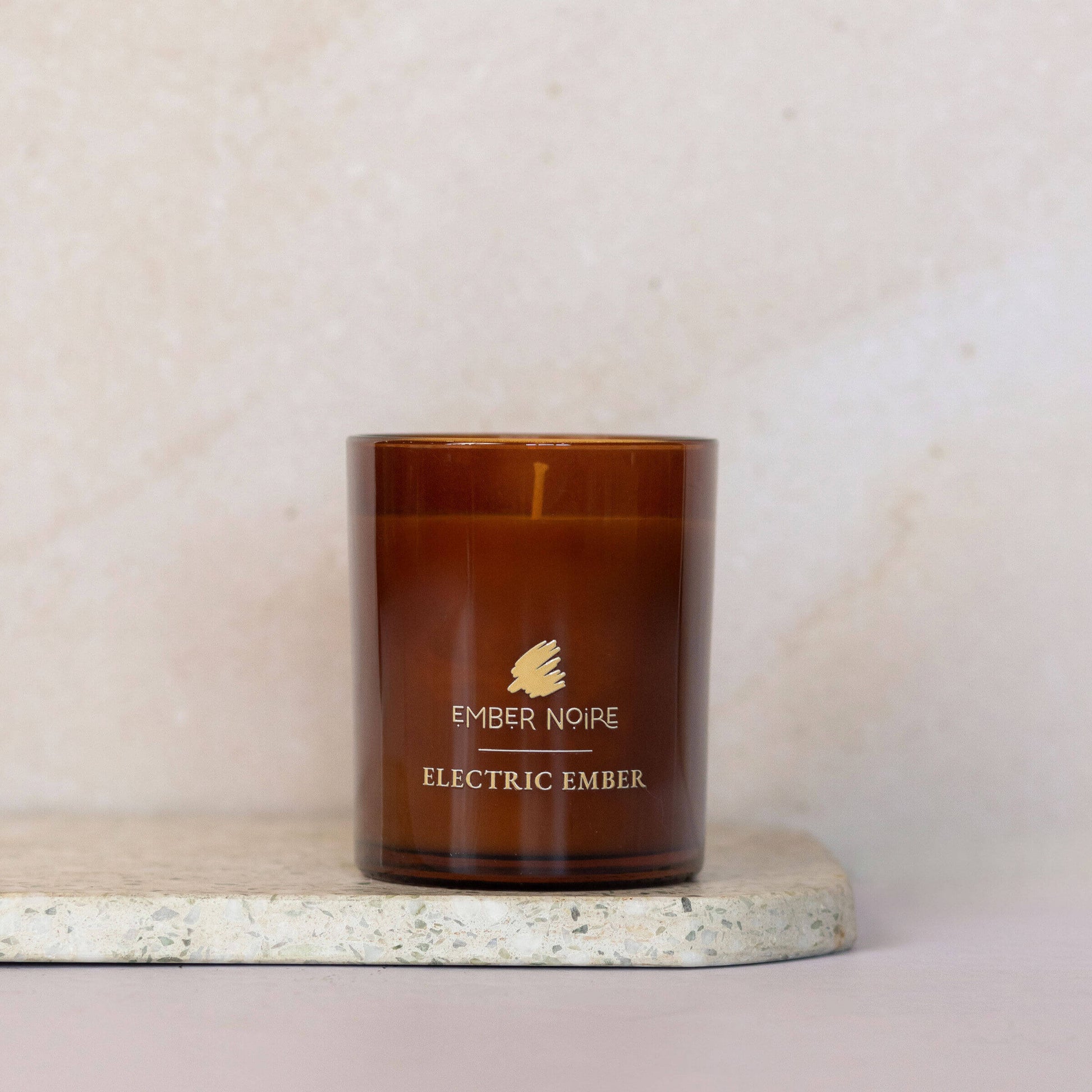 Electric Ember Essential Oil scented Candle –  spices and warm light – bold and spicy aromatherapy soy candle on marble slate 