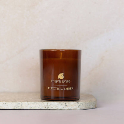 Electric Ember Essential Oil scented Candle –  spices and warm light – bold and spicy aromatherapy soy candle on marble slate 