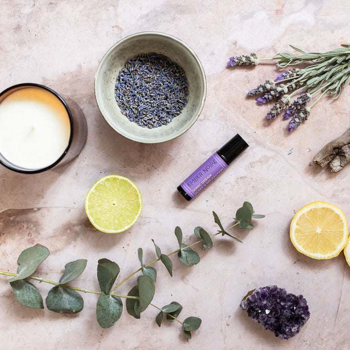Sonic Dream lavender scented soy wax candle and aromatherapy relaxation pulse point roller flat lay with natural ingredients 