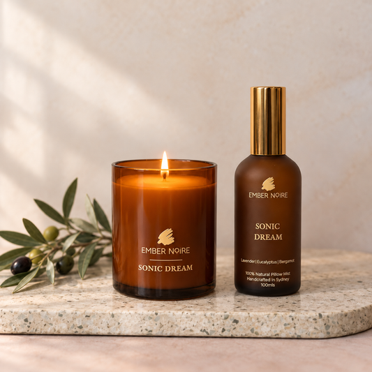 Ember Noire Candle and Mist Set in Sonic Dream, lit amber glass soy candle beside the Sonic Dream pillow mist on a terrazzo board