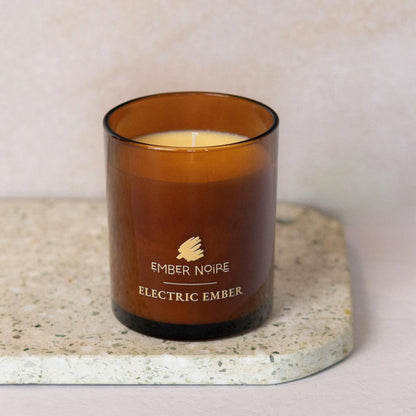 Electric Ember scented candle detail showing amber jar and wax texture